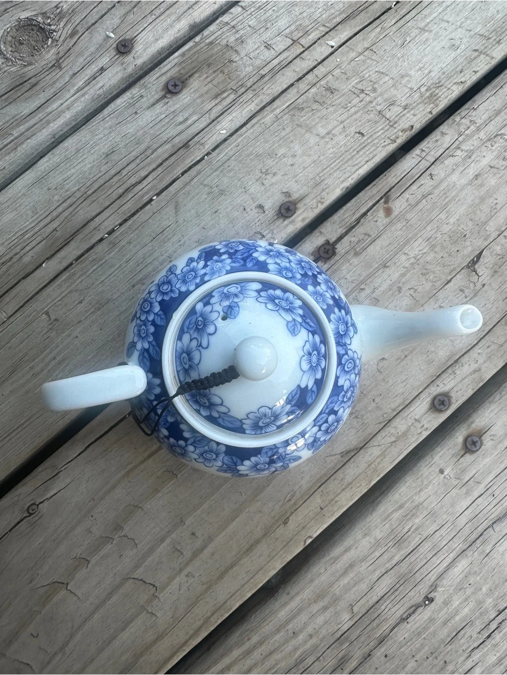 Blue and white floral teapot with butterfly design